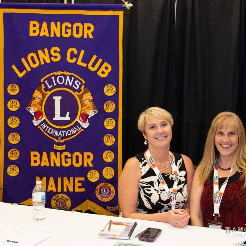 photo of holly taylor and woman next to bangor lions club banner