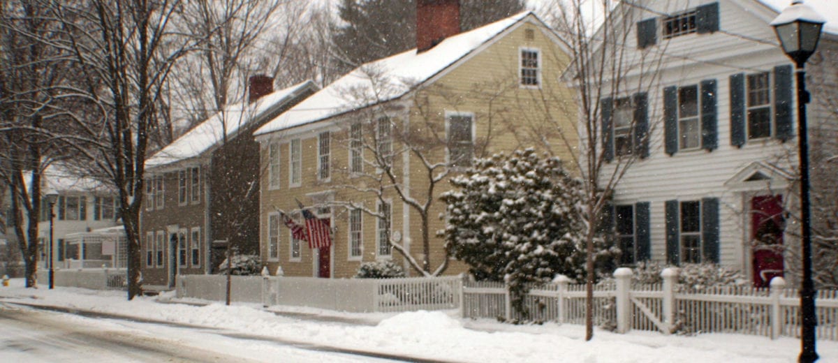 Homes along a sidewalk in the snow