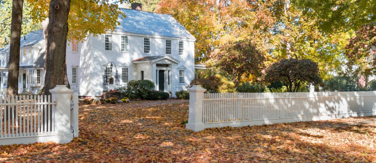 Historic federal style home with a white picket fence in Deerfield, Massachusetts.